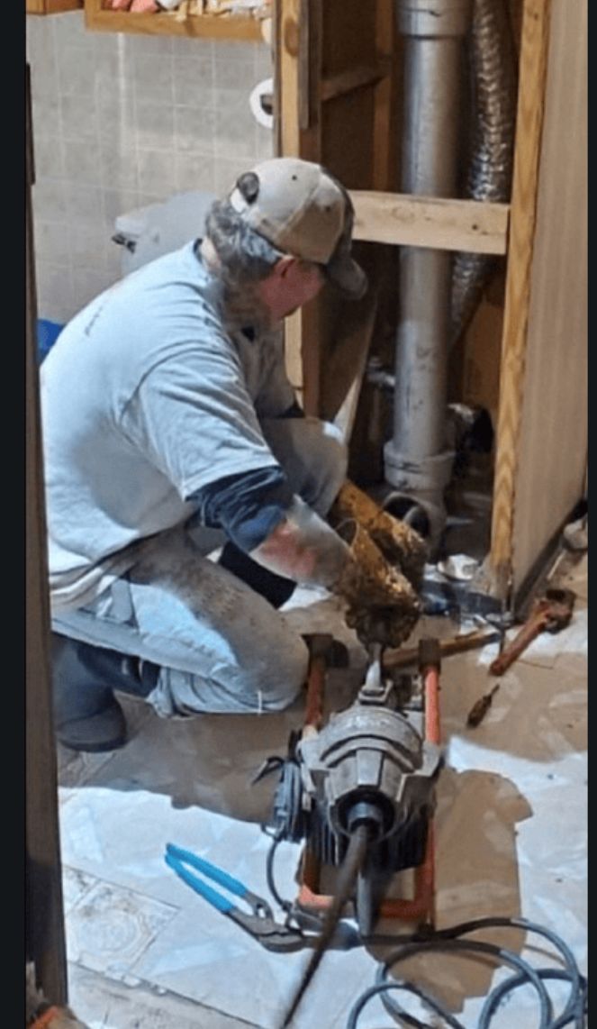 Josh Theilen operating a sewer drain cleaning machine